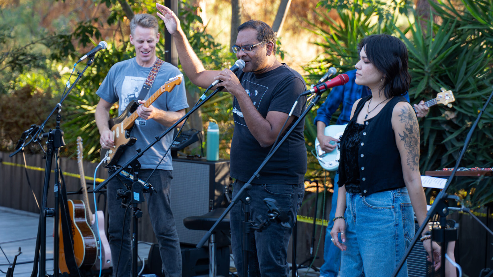 Alex, Samit, and QT performing live